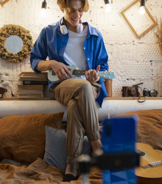 teenage-boy-recording-music-with-his-guitar-his-home-studio